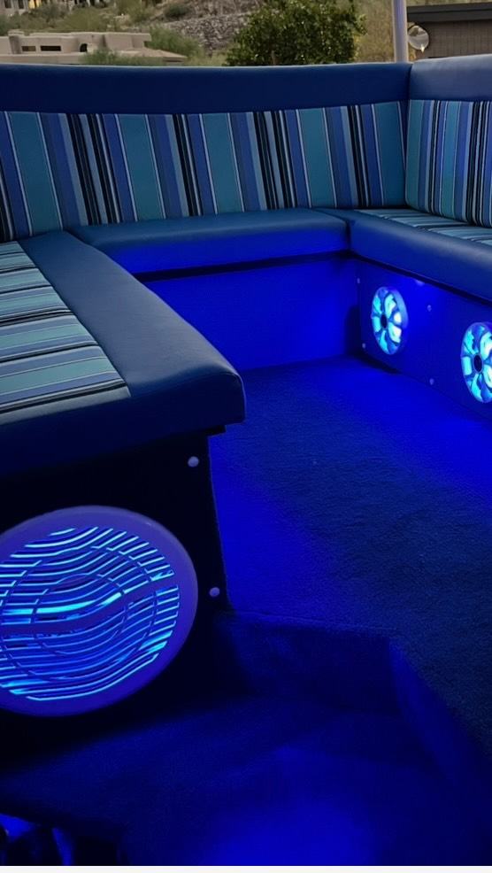 Lit-up speakers and striped bench seats inside a Capri Car