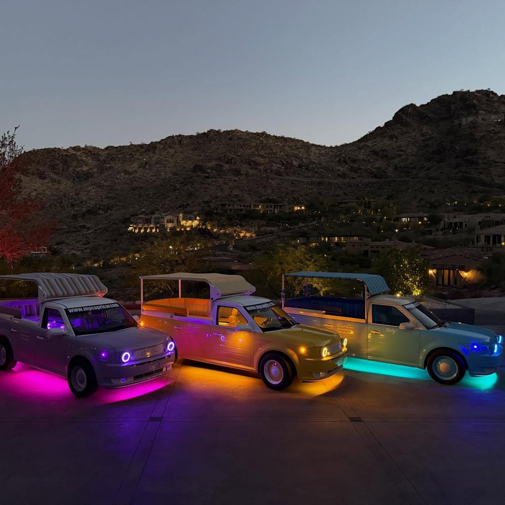 The fleet glowing in pink, gold and teal at dusk