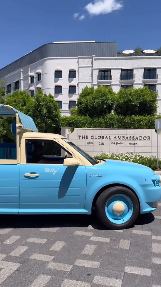 The blue Capri Car waiting at a Scottsdale hotel entrance