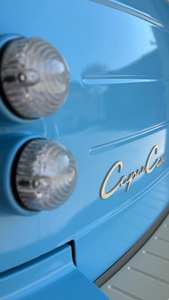 The chrome Capri Car script on a blue door